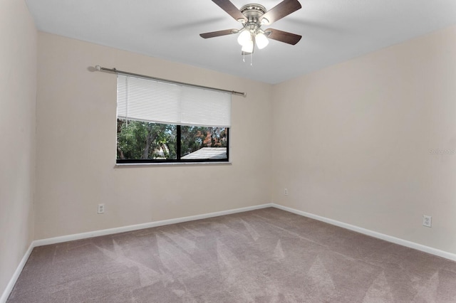 carpeted empty room featuring ceiling fan