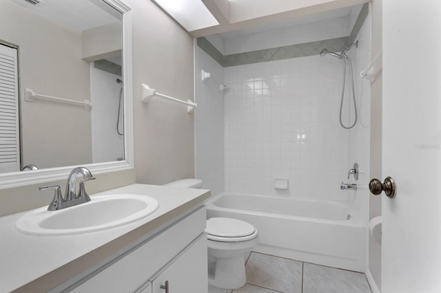 full bathroom featuring vanity, toilet, tiled shower / bath combo, and tile patterned flooring