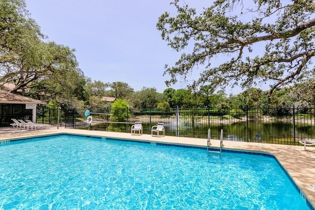 view of pool featuring a water view