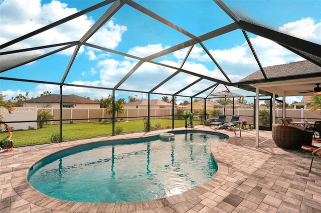 view of swimming pool featuring a lanai, a lawn, ceiling fan, and a patio area