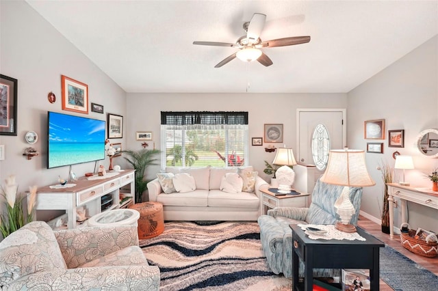 living room with wood-type flooring, ceiling fan, and lofted ceiling