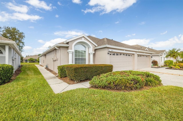 view of front of property featuring a front lawn and a garage