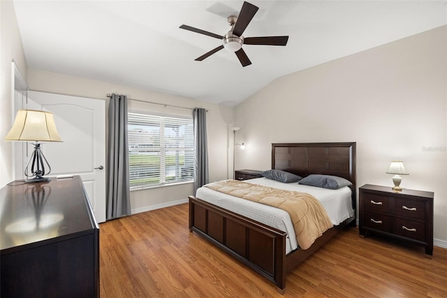 bedroom featuring light wood-type flooring, ceiling fan, and vaulted ceiling