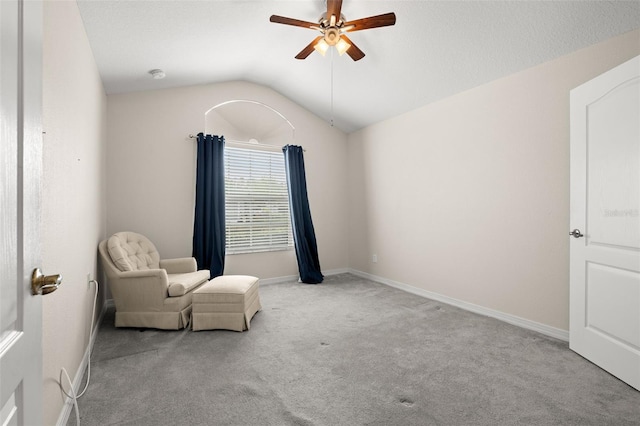 sitting room featuring ceiling fan, light colored carpet, and lofted ceiling