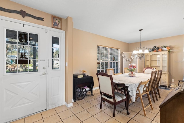 dining space featuring a chandelier, a healthy amount of sunlight, and light tile patterned floors