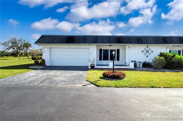 ranch-style house featuring a front yard and a garage