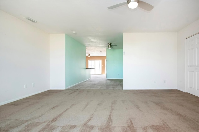 carpeted spare room featuring ceiling fan