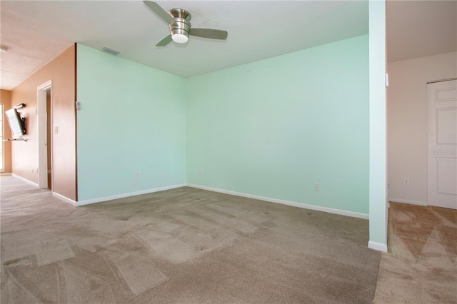 unfurnished room featuring light carpet and ceiling fan