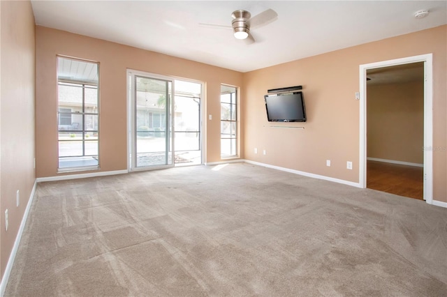 unfurnished living room featuring light colored carpet and ceiling fan