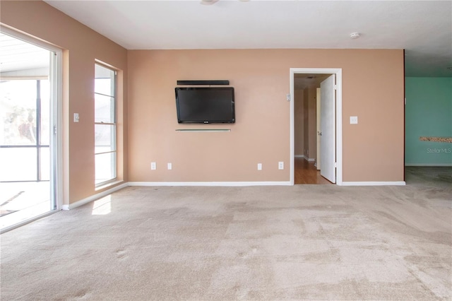 unfurnished living room with light colored carpet