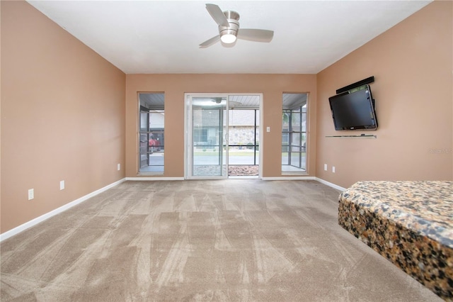 bedroom featuring ceiling fan, light carpet, and access to outside