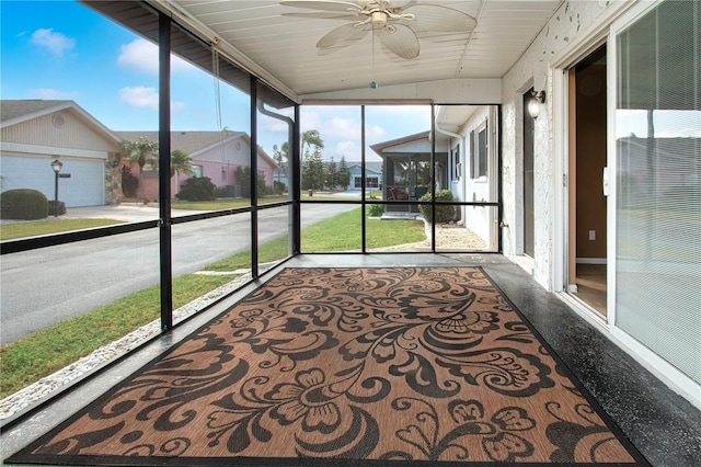 unfurnished sunroom with lofted ceiling and ceiling fan