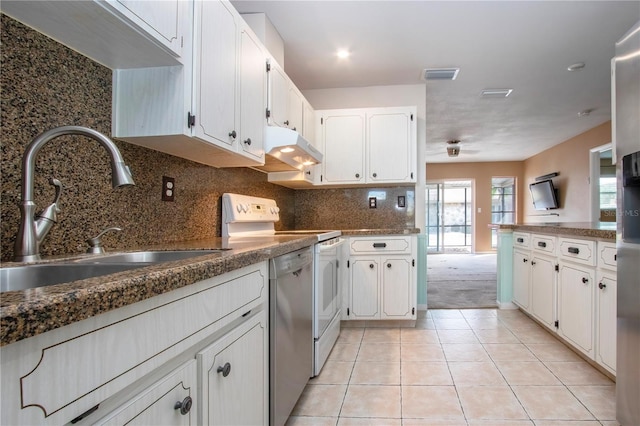 kitchen with tasteful backsplash, light tile patterned floors, white cabinetry, white range with electric cooktop, and sink