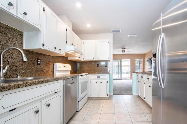 kitchen with sink, appliances with stainless steel finishes, white cabinetry, and light tile patterned floors