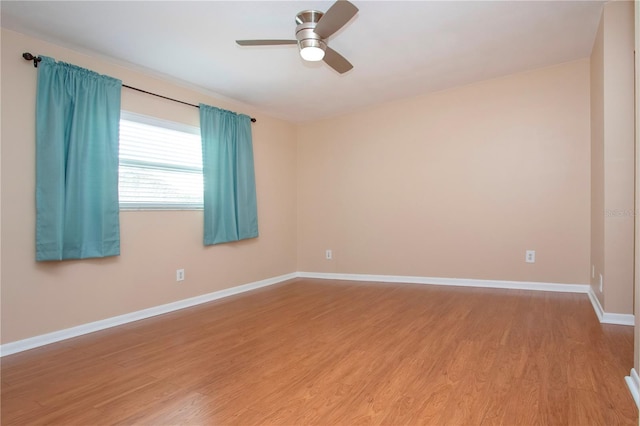 spare room featuring hardwood / wood-style floors and ceiling fan