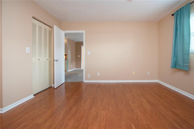 empty room with hardwood / wood-style flooring