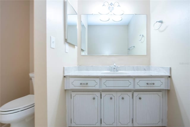 bathroom featuring toilet and vanity