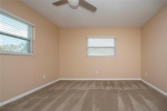 carpeted spare room with ceiling fan