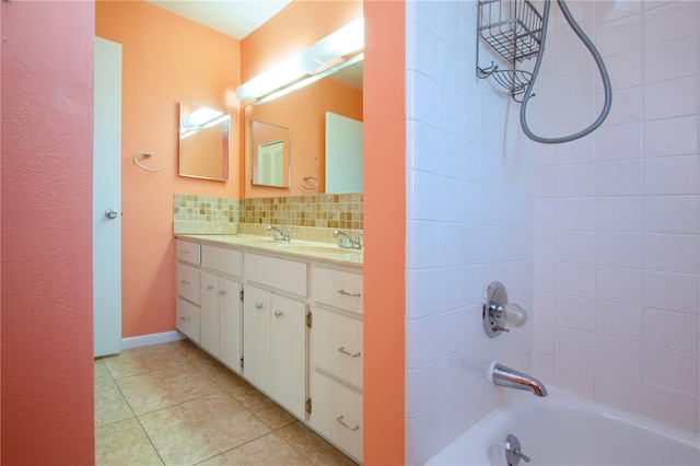 bathroom featuring vanity, backsplash, tiled shower / bath combo, and tile patterned flooring