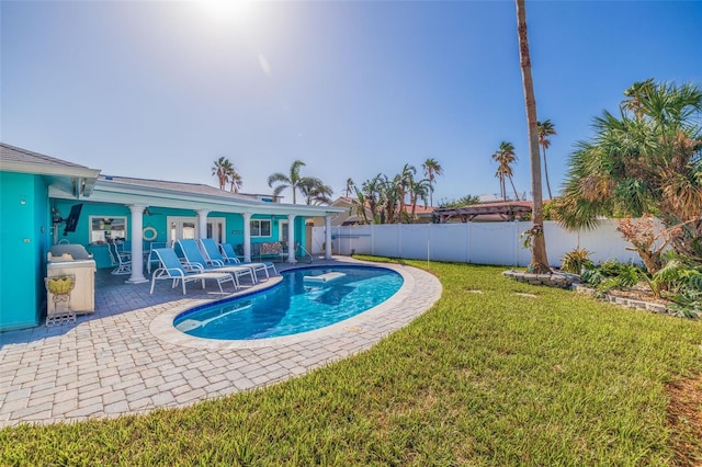 view of swimming pool with a patio and a lawn