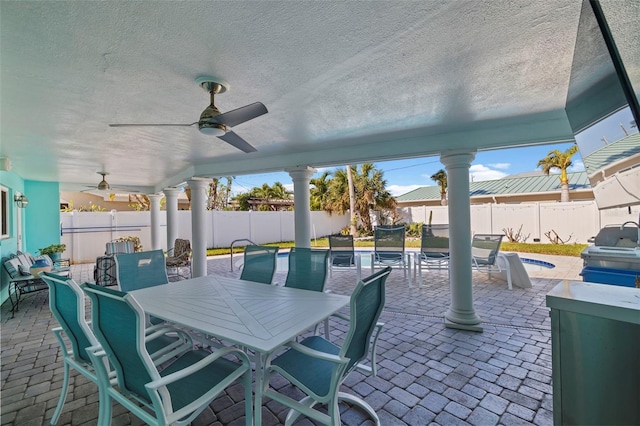 view of patio / terrace with ceiling fan and a swimming pool