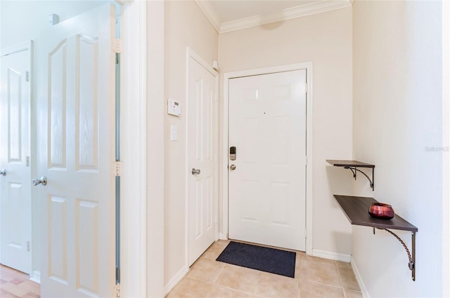 entryway with crown molding and light tile patterned floors