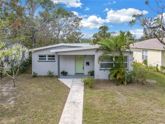 ranch-style home with a front lawn