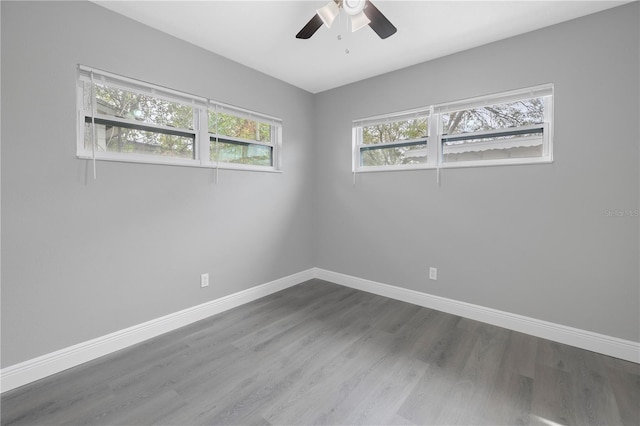 empty room with hardwood / wood-style floors, plenty of natural light, and ceiling fan