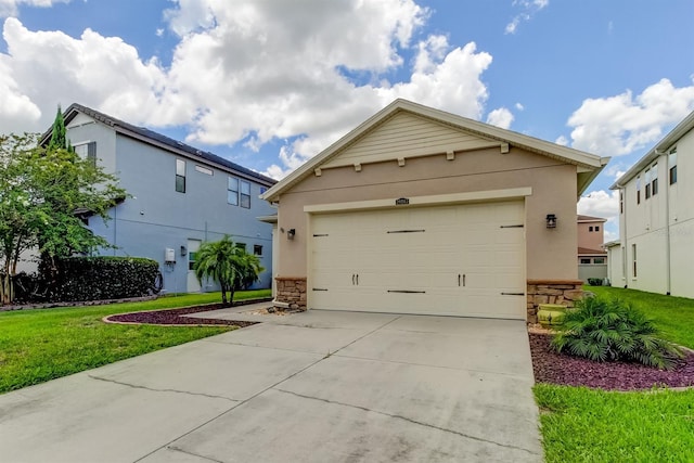 view of front property featuring a garage and a front lawn