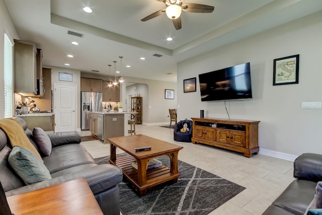 tiled living room with ceiling fan