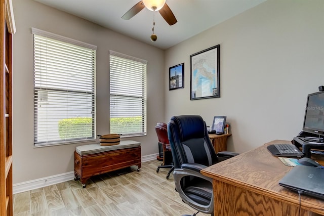 office area with light wood-type flooring and ceiling fan