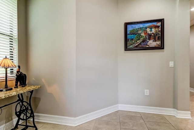 corridor featuring light tile patterned floors