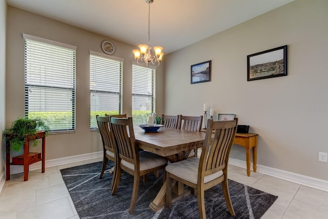 dining area featuring a wealth of natural light, light tile patterned floors, and an inviting chandelier