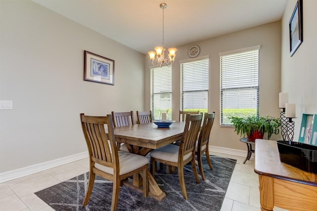 tiled dining area featuring an inviting chandelier