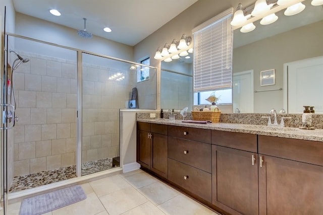 bathroom featuring walk in shower, tile patterned flooring, and vanity