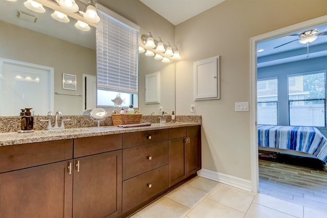 bathroom with tile patterned flooring, a wealth of natural light, vanity, and ceiling fan