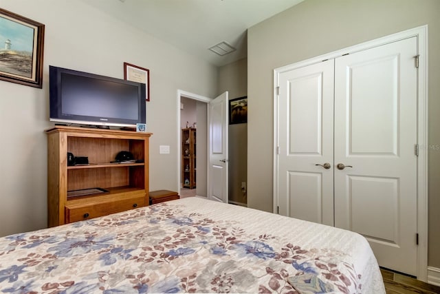 bedroom featuring hardwood / wood-style floors and a closet