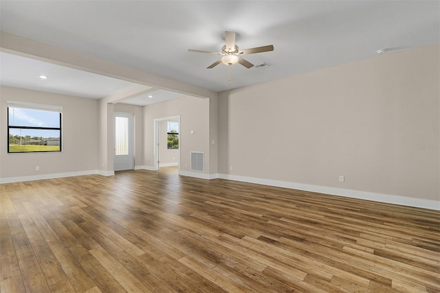 unfurnished room featuring light hardwood / wood-style flooring, ceiling fan, and plenty of natural light