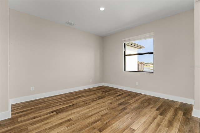 unfurnished room featuring wood-type flooring