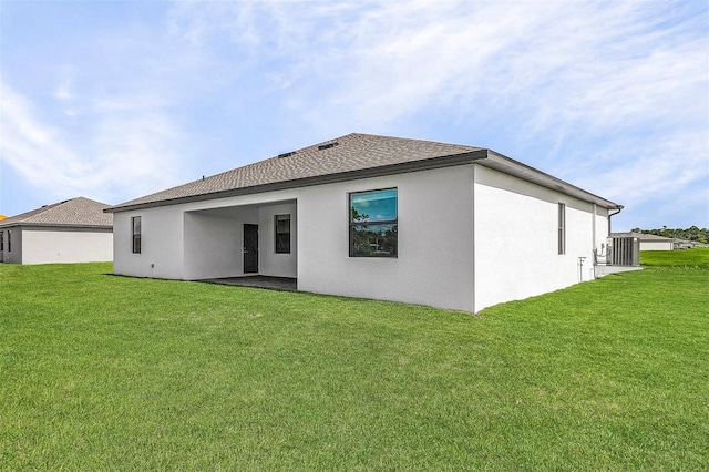 rear view of house with a yard