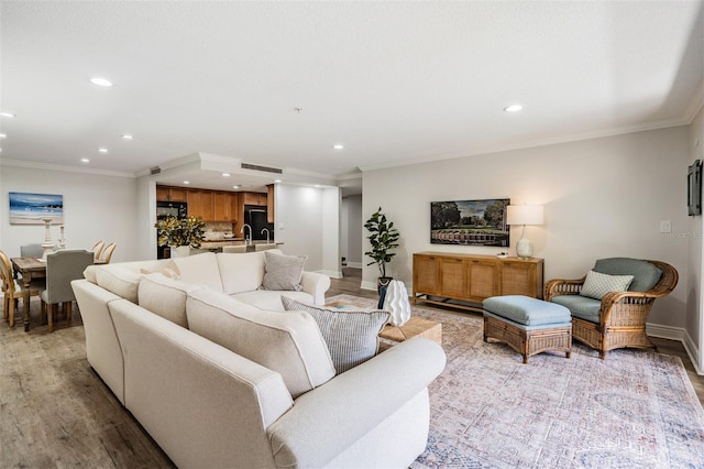 living room featuring crown molding and light wood-type flooring