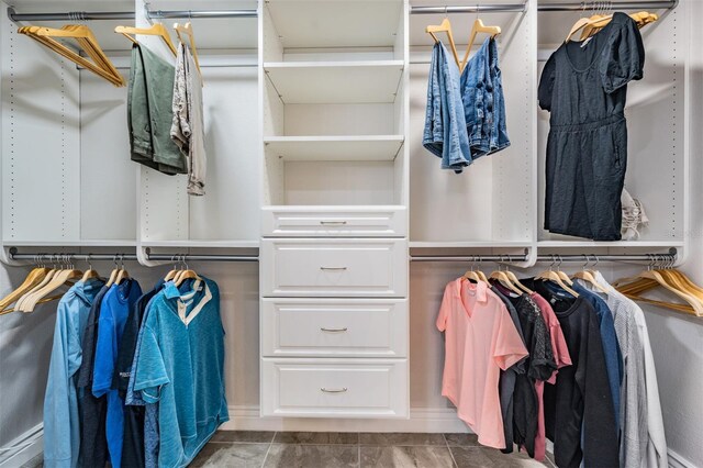 spacious closet featuring dark tile patterned flooring