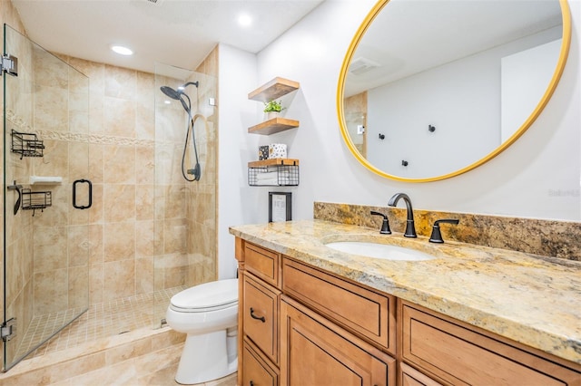 bathroom with vanity, tile patterned floors, toilet, and an enclosed shower