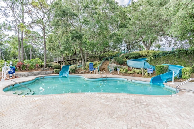 view of pool featuring a patio area and a water slide