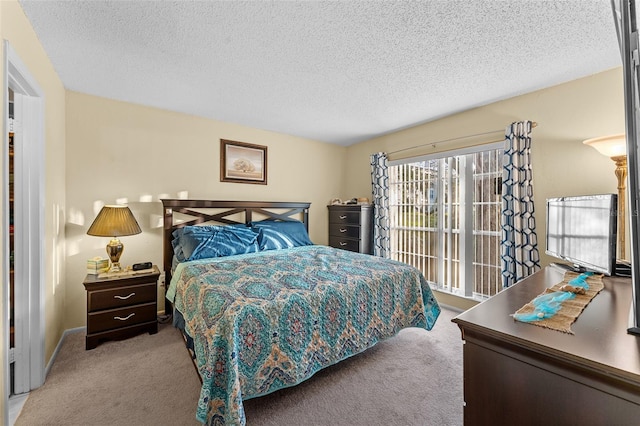 carpeted bedroom featuring a textured ceiling