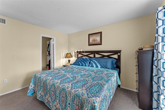 bedroom featuring carpet and a textured ceiling