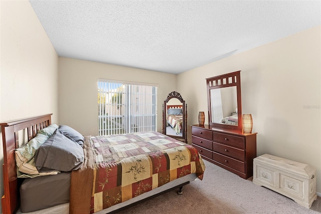 carpeted bedroom featuring a textured ceiling