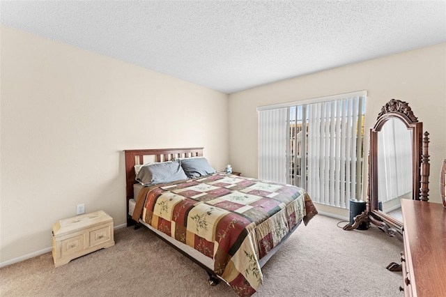 bedroom with a textured ceiling and light colored carpet