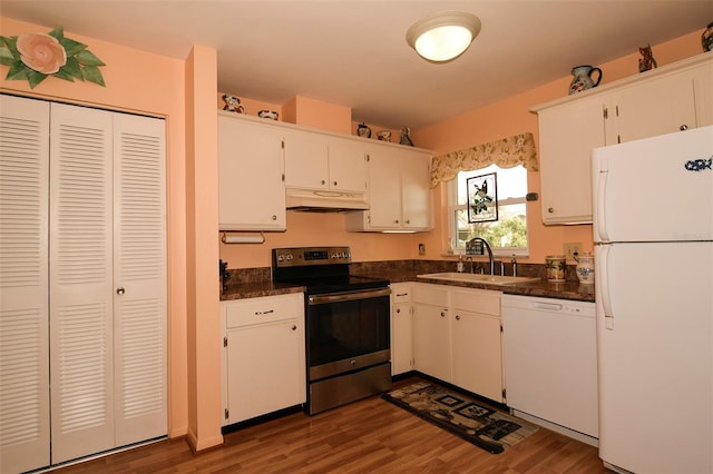 kitchen with sink, white cabinetry, white appliances, and dark hardwood / wood-style flooring