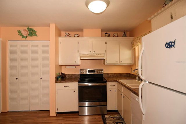 kitchen with sink, dark wood-type flooring, white cabinets, and white appliances